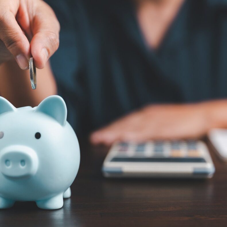 Saving investment banking finance concept. Stack of coins with piggy bank on the table. Growth of loan and investment business idea. Asset Management, Funds, Liabilities, Deposits, Income, Successful.